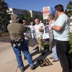 James Van Praagh talks with protesters